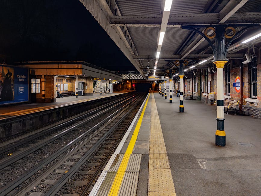 The image depicts Maida Vale underground station platform at night with empty train tracks extending into the darkness. The platform is illuminated by overhead lighting, showing a clean, well-maintain